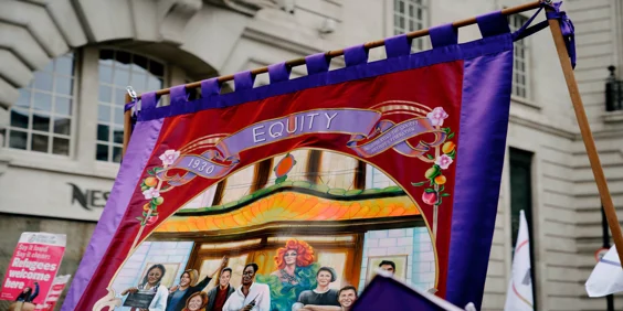 Painted purple and red Equity Banner with the date 1930, showing a variety of different performers.