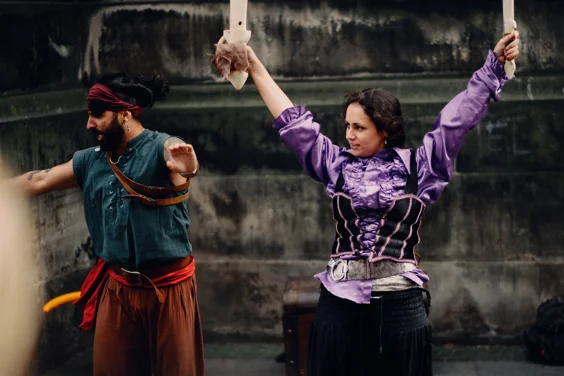 Two street performers in colourful pirate costumes 